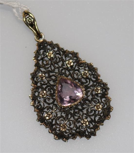 An early 20th century pierced 15ct gold and amethyst pear shaped pendant, 2in.